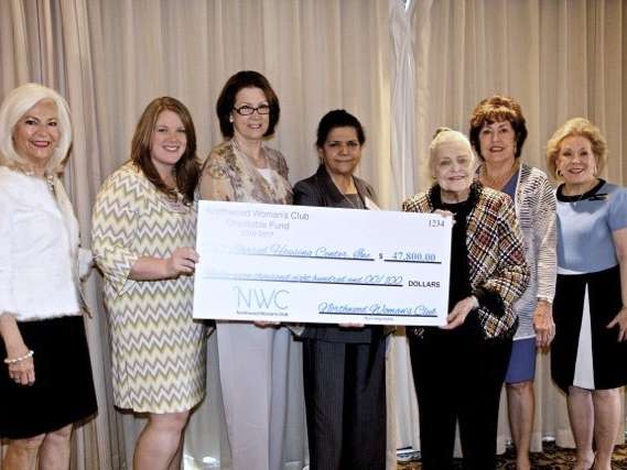 Supporters holding up a large donation check